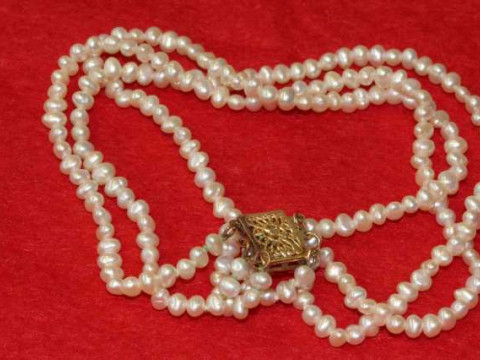 Graduated cultured pearl and enamel necklace together with a three-strand...