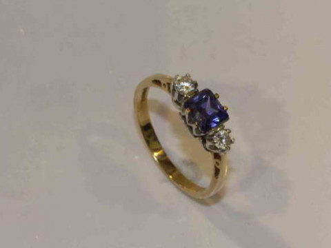 A tanzanite and diamond ring, the square cut tanzanite four claw set between...
