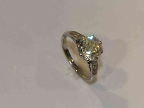 A diamond ring, the brilliant cut diamond eight claw set in a pierced...