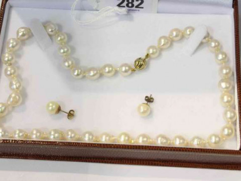 Baroque cultured pearl uniform single row necklace on a yellow gold clasp;...
