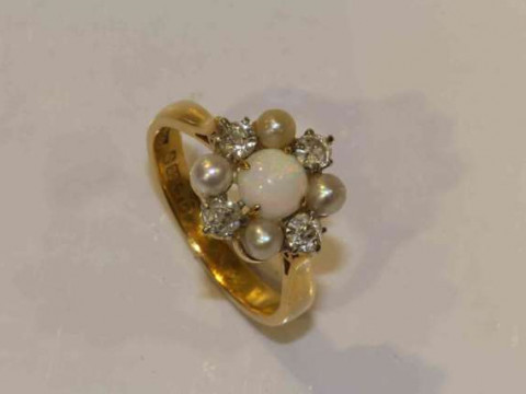 An opal, diamond and seed pearl ring, the round cabochon cut opal four...