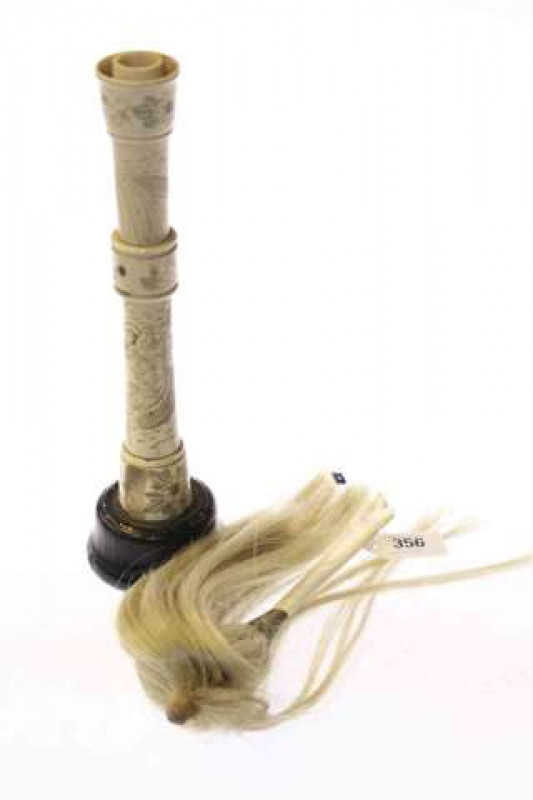 Bone-handled duster and a Chinese engraved bone candlestick (2)