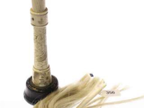 Bone-handled duster and a Chinese engraved bone candlestick (2)