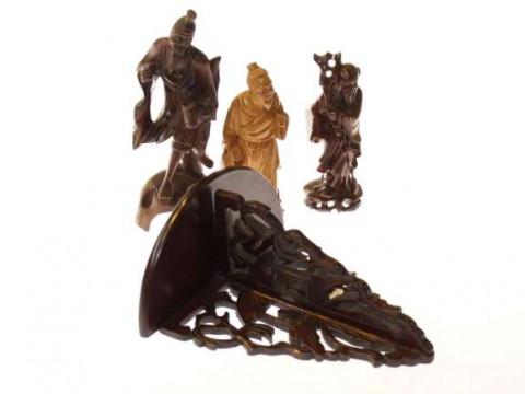 Three Oriental carved figures and a wall bracket (4)