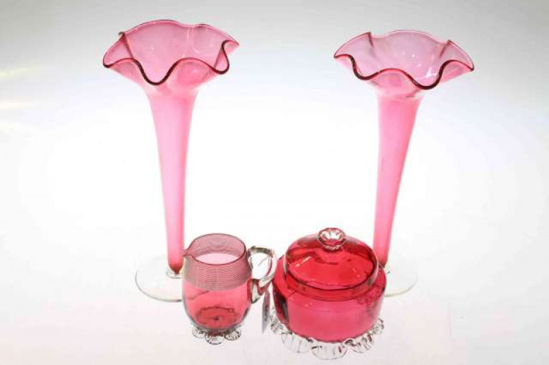 Four pieces of cranberry glass