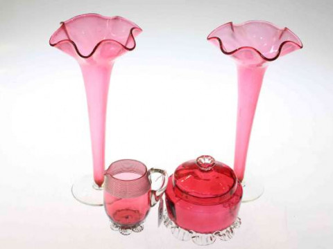 Four pieces of cranberry glass