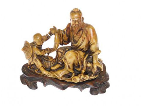 Oriental soapstone carving of fisherman and child on wood stand