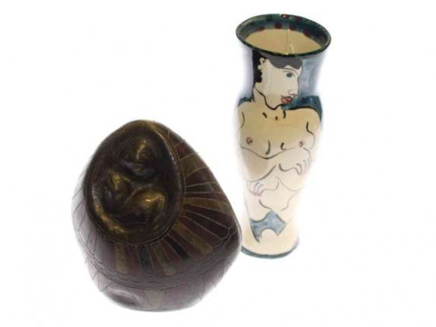 Tribal carving of sloths and Karen Atherley vase