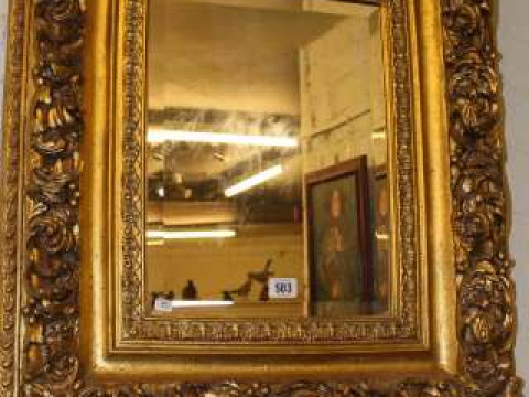 Ornate gilt framed bevelled wall mirror