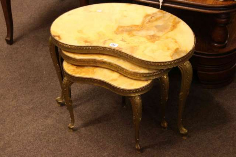 Nest of three onyx and gilt kidney shaped tables