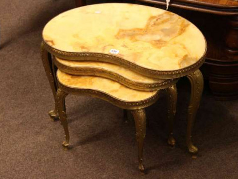 Nest of three onyx and gilt kidney shaped tables