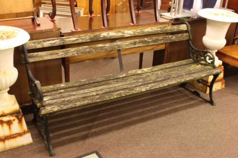 Weathered cast and wood slat garden bench