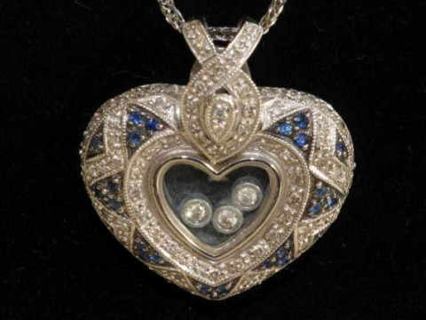 Diamond and blue stone heart-shaped pendant in the style of Chopard