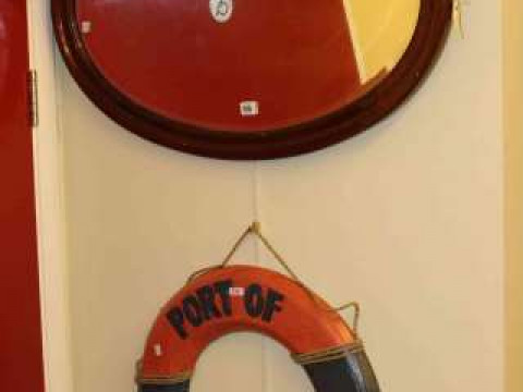 Oval framed wall mirror and novelty life belt (2)