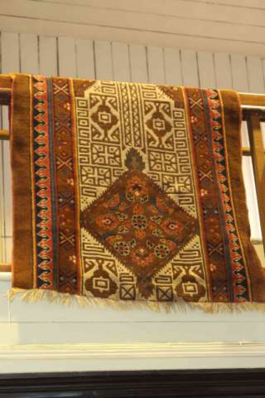 Persian design rug with a brown ground. 2.10m x 1.02m