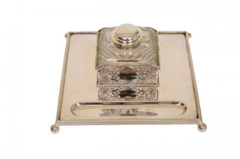 A VICTORIAN SILVER INKWELL, George Fox, London 1880, square with beaded border and ball feet, the glass ink with hinged silver lid. 26cm
