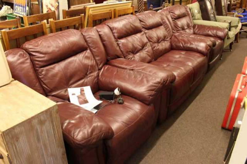 Barkers burgundy leather three piece lounge suite comprising two seater settee, electric reclining chair and easy chair