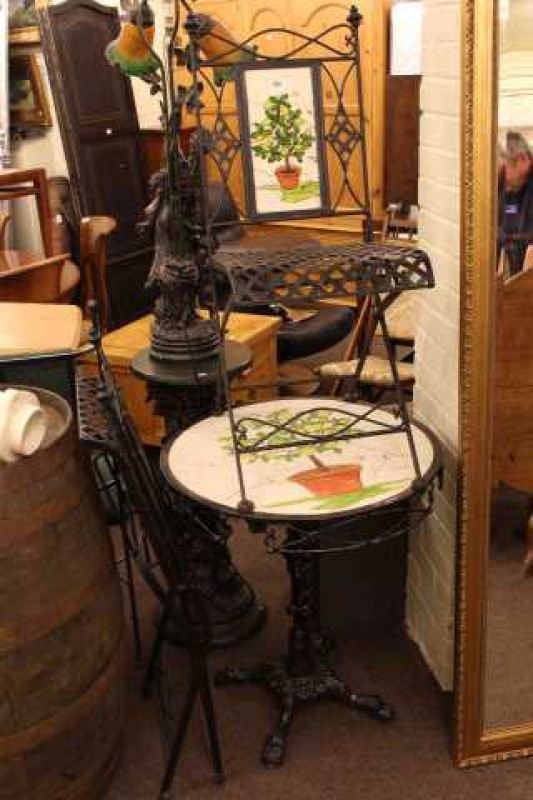 Circular painted and cast base patio table and two folding chairs