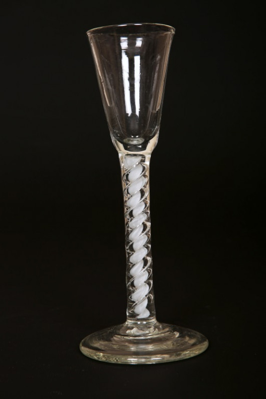 A CONTINENTAL CORDIAL GLASS, late 18th Century, with cotton twist stem and domed circular foot; together with a facon de venise wine glass, the knopped stem moulded with masks and flowerheads and with aventurine inclusions; and a small 18th Century spirit