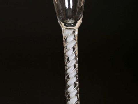 A CONTINENTAL CORDIAL GLASS, late 18th Century, with cotton twist stem and domed circular foot; together with a facon de venise wine glass, the knopped stem moulded with masks and flowerheads and with aventurine inclusions; and a small 18th Century spirit thumbnail