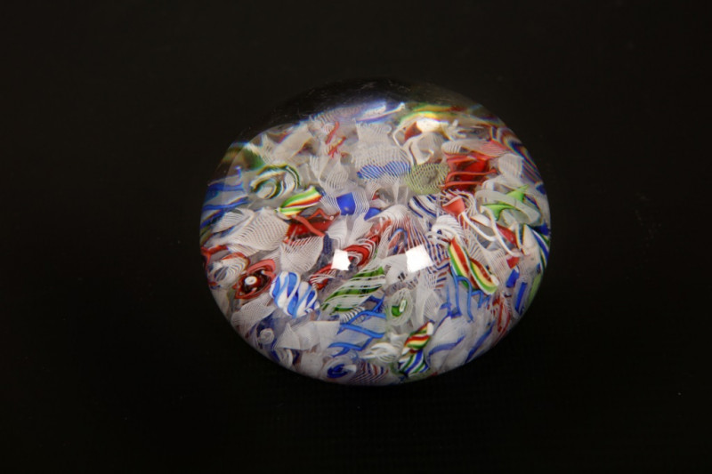 A 19th CENTURY SCRAMBLED MILLEFIORE PAPERWEIGHT, POSSIBLY BACCARAT, with a random arrangement of polychrome and white canes. Diameter 7.5cm