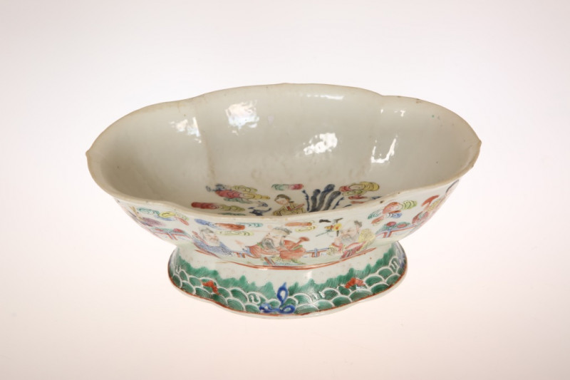 A CHINESE FAMILLE ROSE PORCELAIN BOWL, of oval lobed form, painted to the interior with a goddess amidst clouds, the exterior with sages and other figures on a spreading foot, iron red seal mark of Jiaqing type. Length 26cm