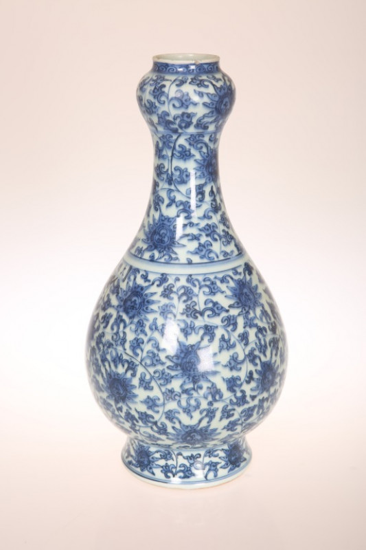 A CHINESE BLUE AND WHITE PORCELAIN VASE, of baluster form, with 'garlic' neck, painted with stylised flowers and foliage and a line of calligraphy, unmarked. 34.5cm 