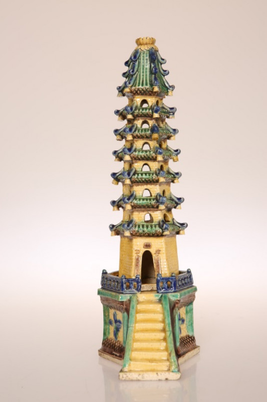 A CHINESE POTTERY MODEL OF A PAGODA, possibly c. 1900, in two parts, glazed in yellow, green, blue and brown. 27.5cm