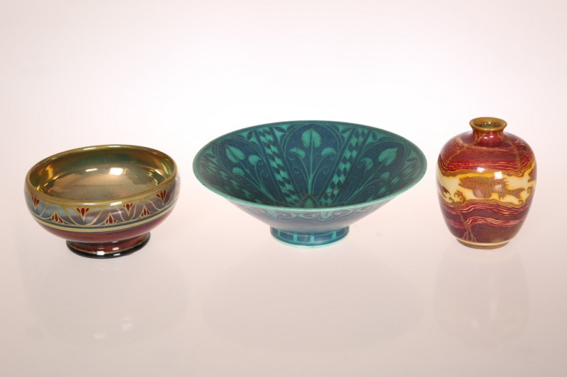 A GROUP OF PILKINGTONS ROYAL LANCASTRIAN, comprising: a small lustre baluster vase painted with a band of carp; a lustre bowl with painted monogram to base; and a conical bowl with a matt glaze with monogram and impressed marks (a/f). (3) First 11cm