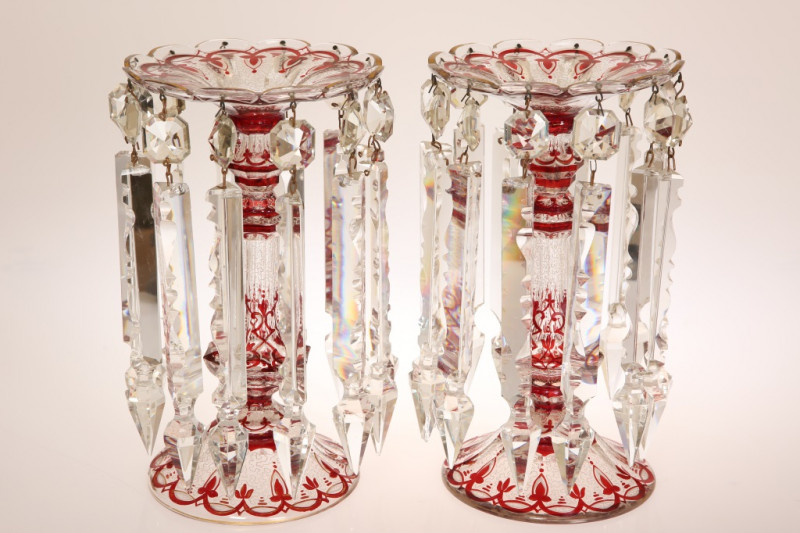 A FINE PAIR OF BOHEMIAN TABLE LUSTRES, CIRCA 1870, picked out with ruby, white and gilt, clear glass drops hanging from a shaped rim. 28.5cm