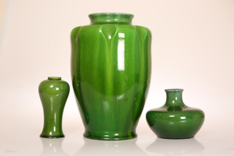 THREE PILKINGTONS ROYAL LANCASTRIAN GREEN-GLAZED VASES, early 20th Century: the largest of hipped baluster form with dimpled shoulder, impressed marks including 2090A; the second of squat baluster form, impressed marks no. 2159; the third of slender balus