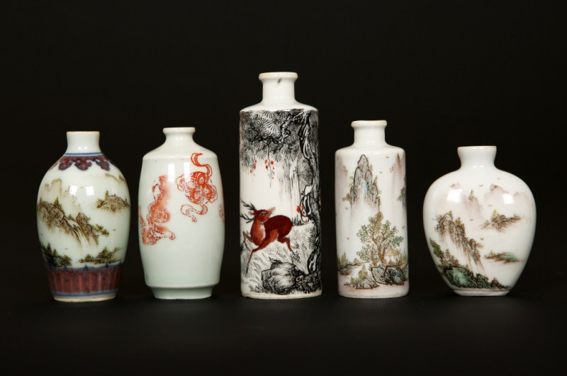 A GROUP OF FIVE CHINESE PORCELAIN SNUFF BOTTLES, of varying shapes, the largest cylindrical, decorated with a stag and crane in a landscape, lacking stoppers. Tallest 9.5cm