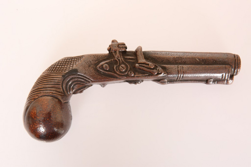 A GLAZED STONEWARE SPIRIT FLASK MODELLED AS A PISTOL, late 19th Century, unmarked. 20cm