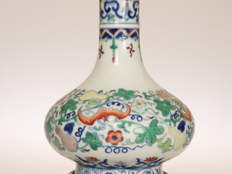 A CHINESE PORCELAIN VASE, of baluster form with elongated neck, painted...