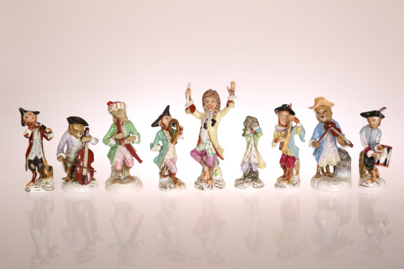 AN ASSEMBLED SET OF NINE GERMAN PORCELAIN MONKEY BAND FIGURES, late 19th Century, in polychrome enamels, six unmarked including the conductor, three (slightly larger) with underglaze blue mark including a violinist. (9) Conductor 15.5cm