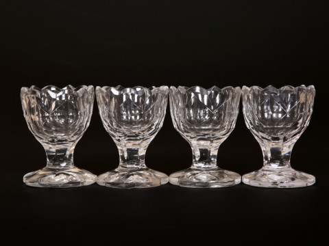 A SET OF FOUR CUT-GLASS SALTS, circa 1800, each with scalloped rim above...