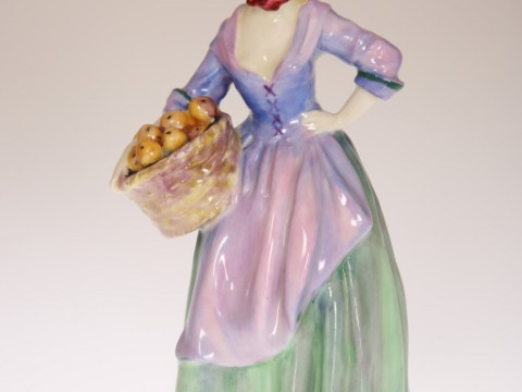 A ROYAL DOULTON FIGURE, THE ORANGE SELLER, HN1325, painted and printed...