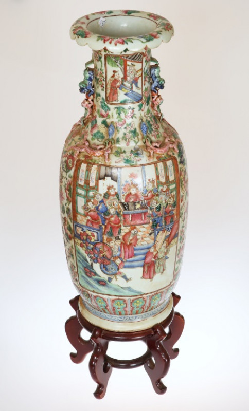 A LARGE CANTON FAMILLE ROSE PORCELAIN BALUSTER VASE, circa 1900, applied with Buddhistic lion handles and with lizards to the neck, painted in enamels with warriors in battle scenes opposed by figures in a courtly setting all against a ground of fruit and