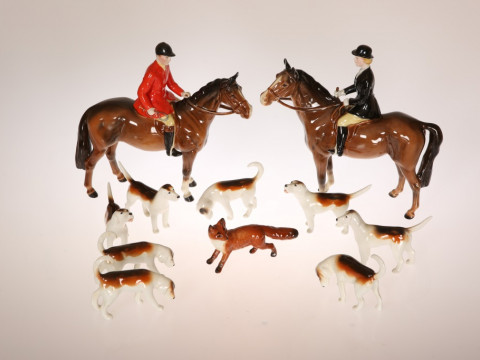 A BESWICK POTTERY HUNTING GROUP, comprising huntsman in a red coat and...