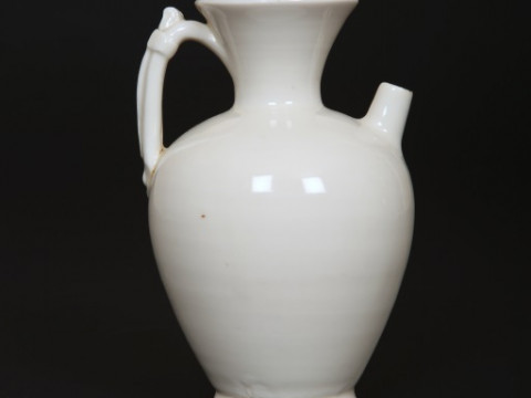 A CHINESE WHITE-GLAZED EWER, SONG DYNASTY, of baluster form, with flared...