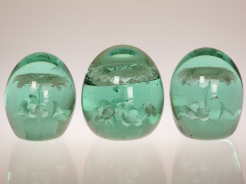 A GROUP OF THREE GREEN GLASS 'DUMP' PAPERWEIGHTS, THIRD QUARTER 19th CENTURY,...