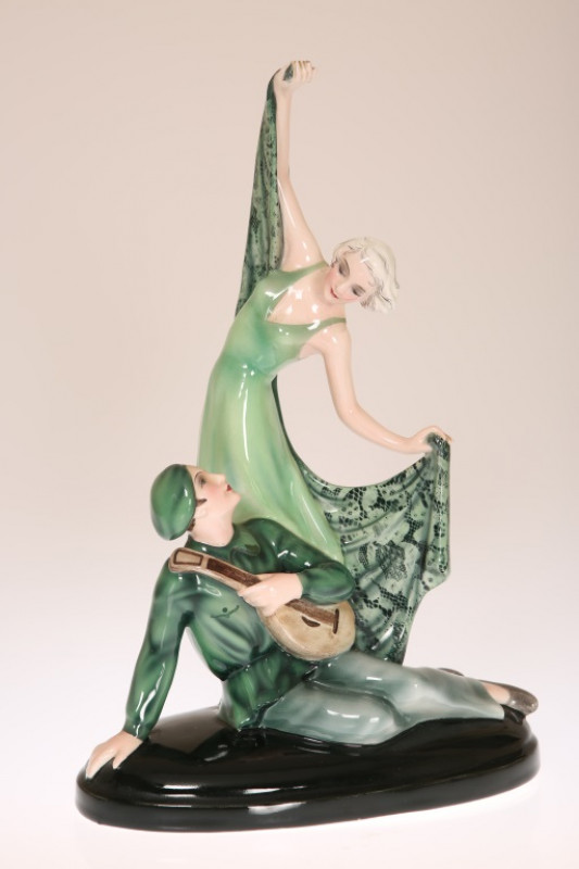 AN AUSTRIAN PORCELAIN FIGURE OF TROUBADOR AND DANCING GIRL IN THE ART DECO TASTE, signed Lorenzl to the base, printed mark Made In Austria and impressed numerals 6765 35 10. 33cm