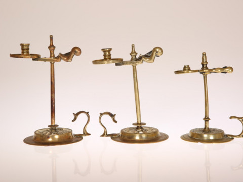 THREE GEORGE III BRASS WAX JACKS, circa 1775, each of characteristic form...