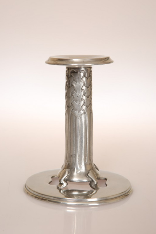 ARCHIBALD KNOX (1864-1933) FOR LIBERTY & CO A TUDRIC PEWTER CANDLESTICK, no. 022, with detachable sconce, cast in low relief with stylised strapwork. 12.5cm