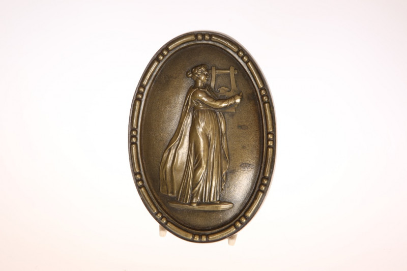 A 19TH CENTURY BRONZE PLAQUE, oval, cast with Apollo playing the lyre. 16.5cm by 11.5cm