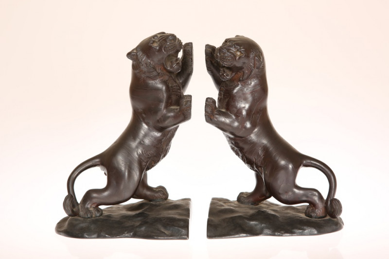 A PAIR OF JAPANESE BRONZE BOOKENDS MODELLED AS TIGERS, MEIJI PERIOD, circa 1900, each rearing, snarling animal on an integral naturalistic base, and bearing signatures. Height 20.5cm