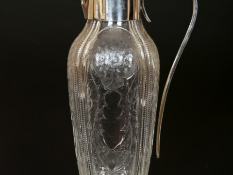 A GEORGE V SILVER-MOUNTED CUT AND FROSTED GLASS CLARET JUG, the silver...