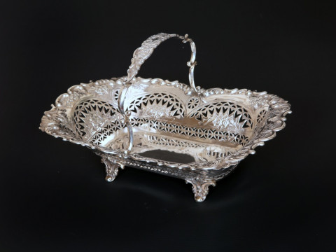 A LATE VICTORIAN SILVER CAKE BASKET, SHEFFIELD 1897, with fixed scroll...