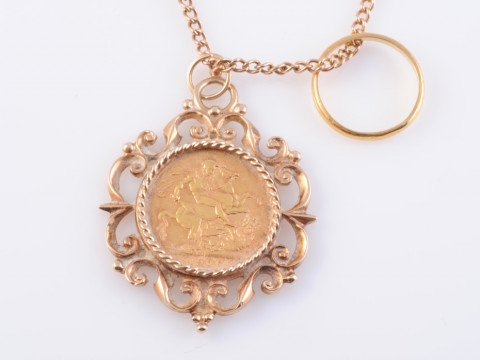 AN EDWARDIAN FULL SOVEREIGN, 1906, in a scrolling 9 carat gold pendant...