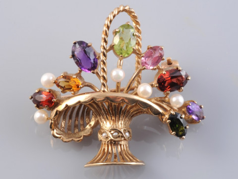 A 9 CARAT GOLD AND MULTI-GEM BROOCH, modelled as a basket of flowers,...